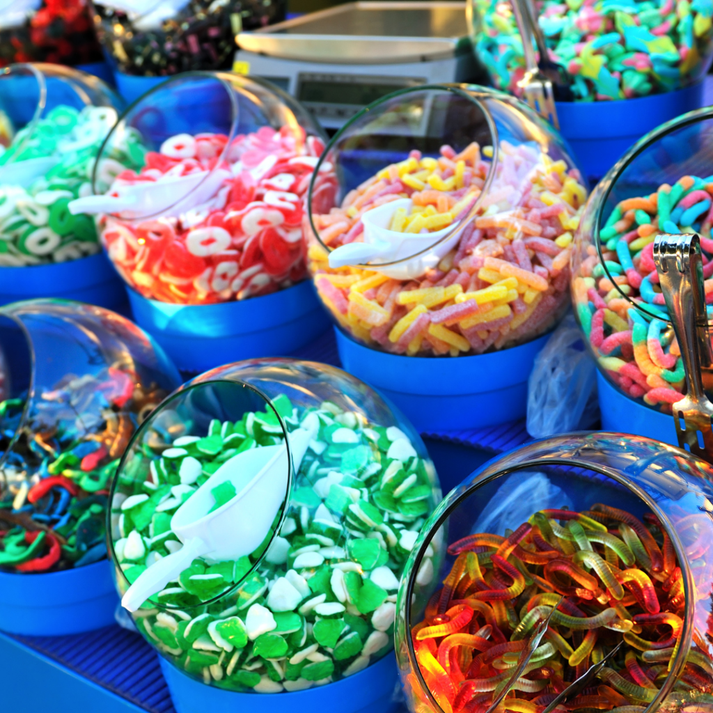 assortment of many jars of little colorful candies to decorate gingerbread house