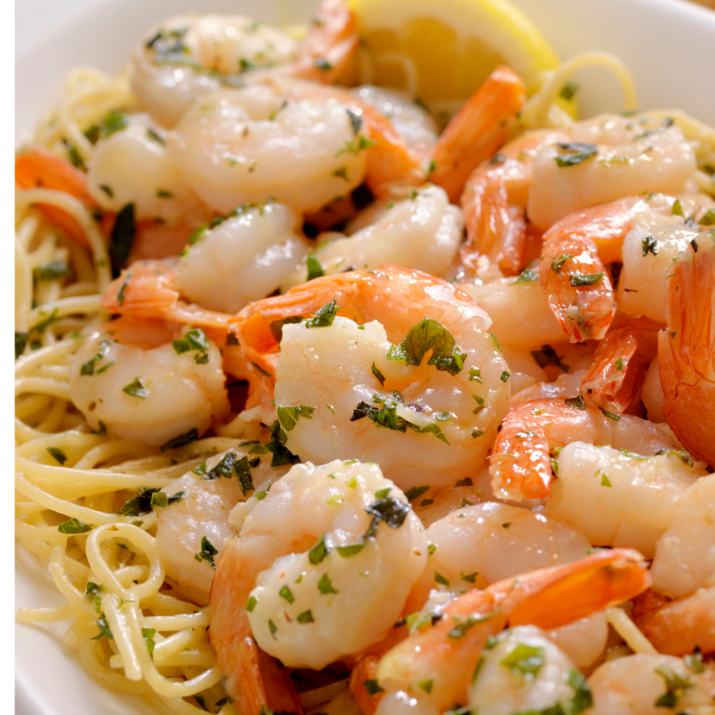 shrimp scampi dinner with wedges of lemons and herbs